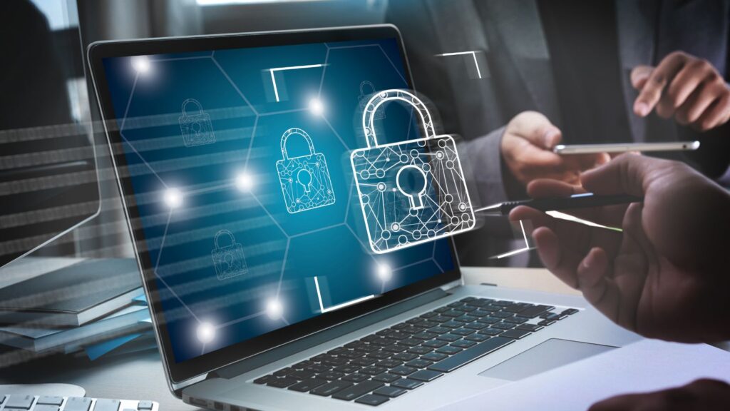 Business professionals reviewing cybersecurity strategy on laptop with digital padlock icons representing data protection, firewall, and secure enterprise systems.