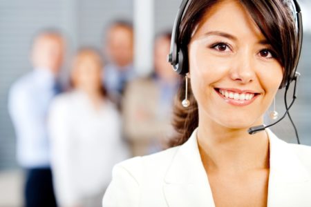 Female customer support operator with a headset and smiling