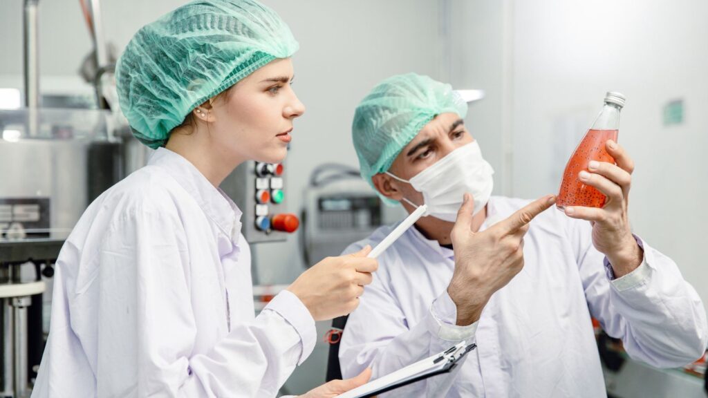 Quality Control and Food Safety Team Inspection the Product Standard in the Food and Drink Factory Production Line