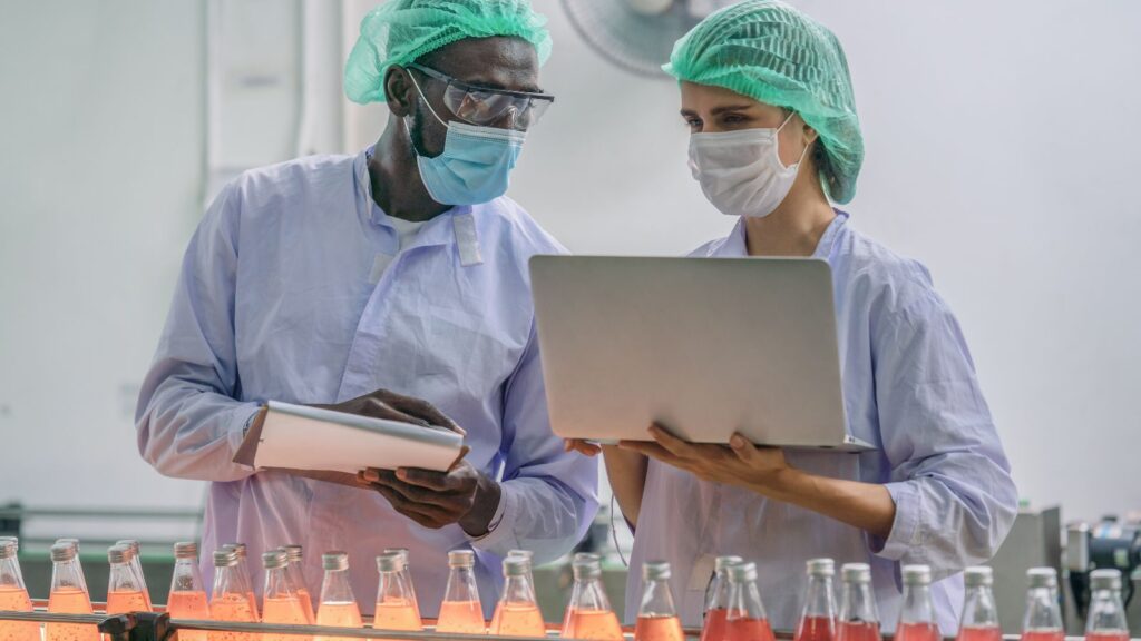 industrial background of beverage factory production line supervisor and worker working together in beverage production line during processing in beverage manufacturing factory