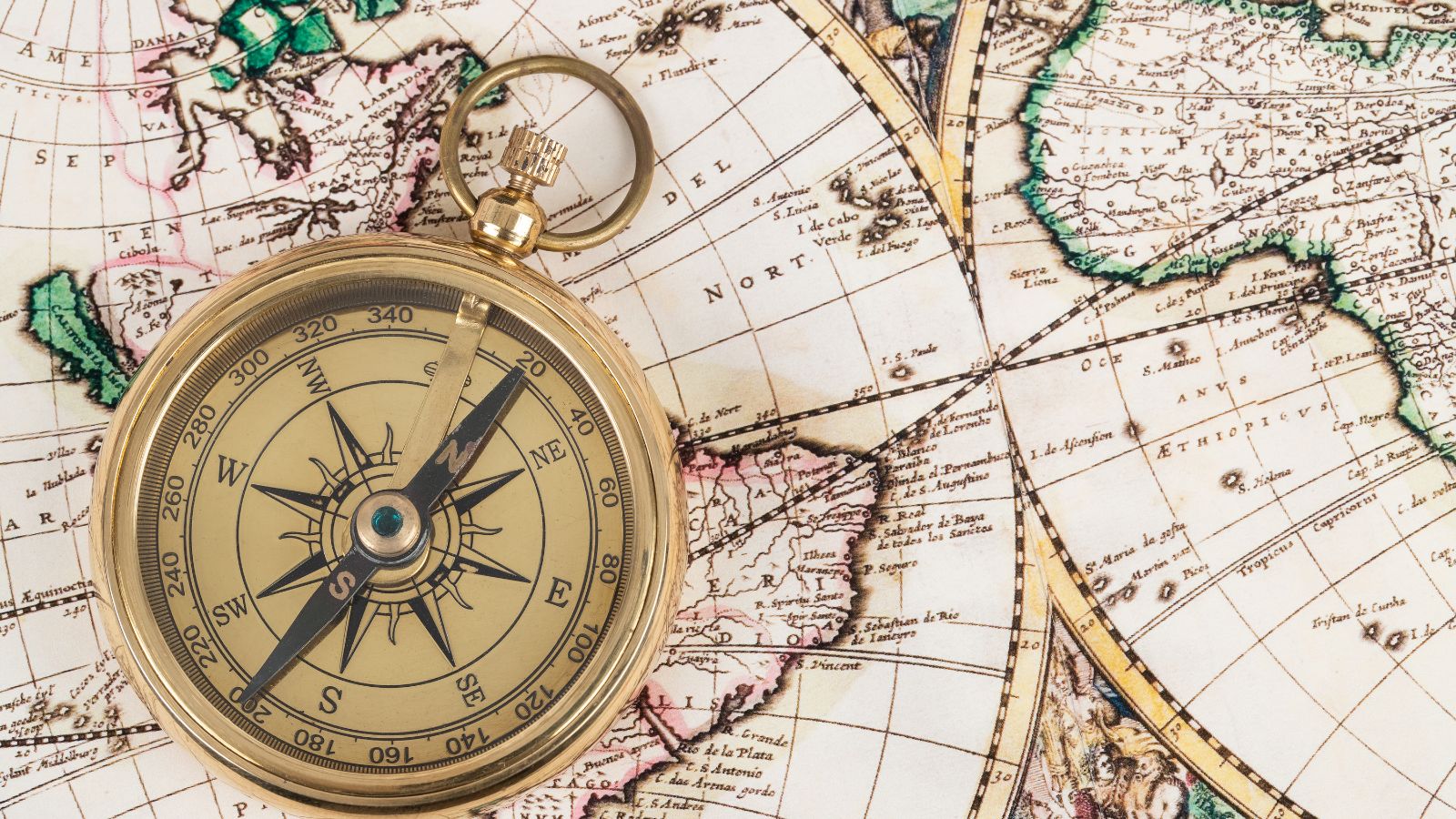 Antique compass on a vintage world map symbolizing navigation and direction—representing global financial control and coordination in Multi-Entity Management with Business Central.