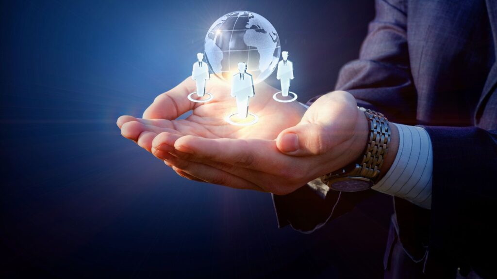 Business Central Multi-Entity Management: Simplifying Global Financial Operations 5 Businessperson holding holographic icons of global team members and a digital globe, symbolizing international collaboration and multi-entity management.