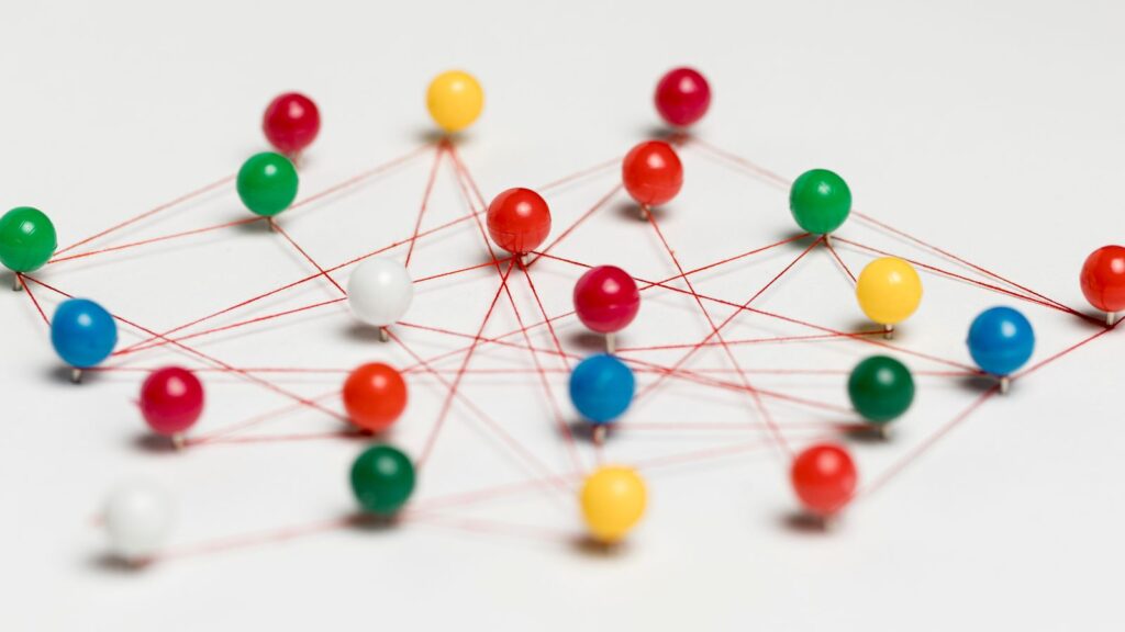 Step-by-Step ERP Migration Roadmap | Move from Legacy ERP to Microsoft Dynamics 365 Business Central 1 Conceptual network of colorful pins connected by red strings representing connections and pathways, symbolizing the complexity of planning an ERP Migration Roadmap from legacy systems to Microsoft Dynamics 365 Business Central.