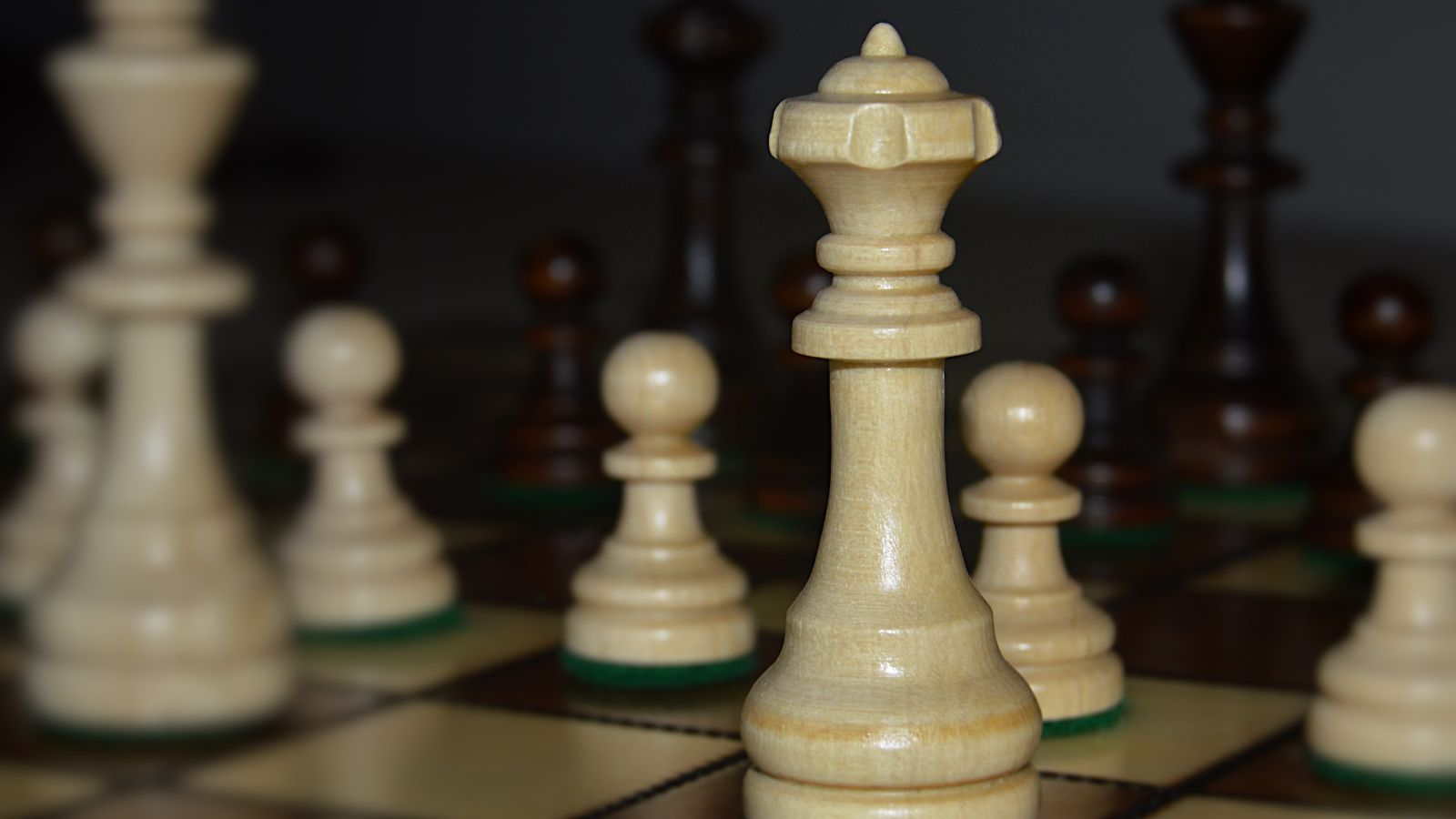 Chess pieces on a chessboard with the white king in focus, symbolizing strategy, leadership, and decision-making in enterprise technology, representing the strategic planning required for a successful Business Central Copilot implementation and AI-driven ERP transformation in Microsoft Dynamics 365 Business Central.